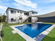 A dual living family home with a pool, shed and coastal...