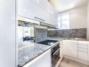 A superb top floor flat in a portered building in...