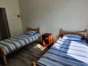 Bed in a comfy twin bedroom, in Broadstone