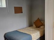 Bed in a comfy twin bedroom, near the Broadstone...