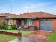 Classic Red Brick Home with a Sunny Backyard