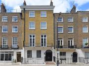 Elegantly renovated six bedroom townhouse in the heart...