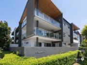 Modern top level apartment in coveted enclave