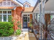 Ornate classic bungalow wrapped in beautiful gardens