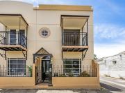 Sunlight, terracotta & vines  rise to Euro style rooftop...