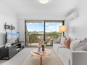 Top floor North facing apartment w/city views & parking